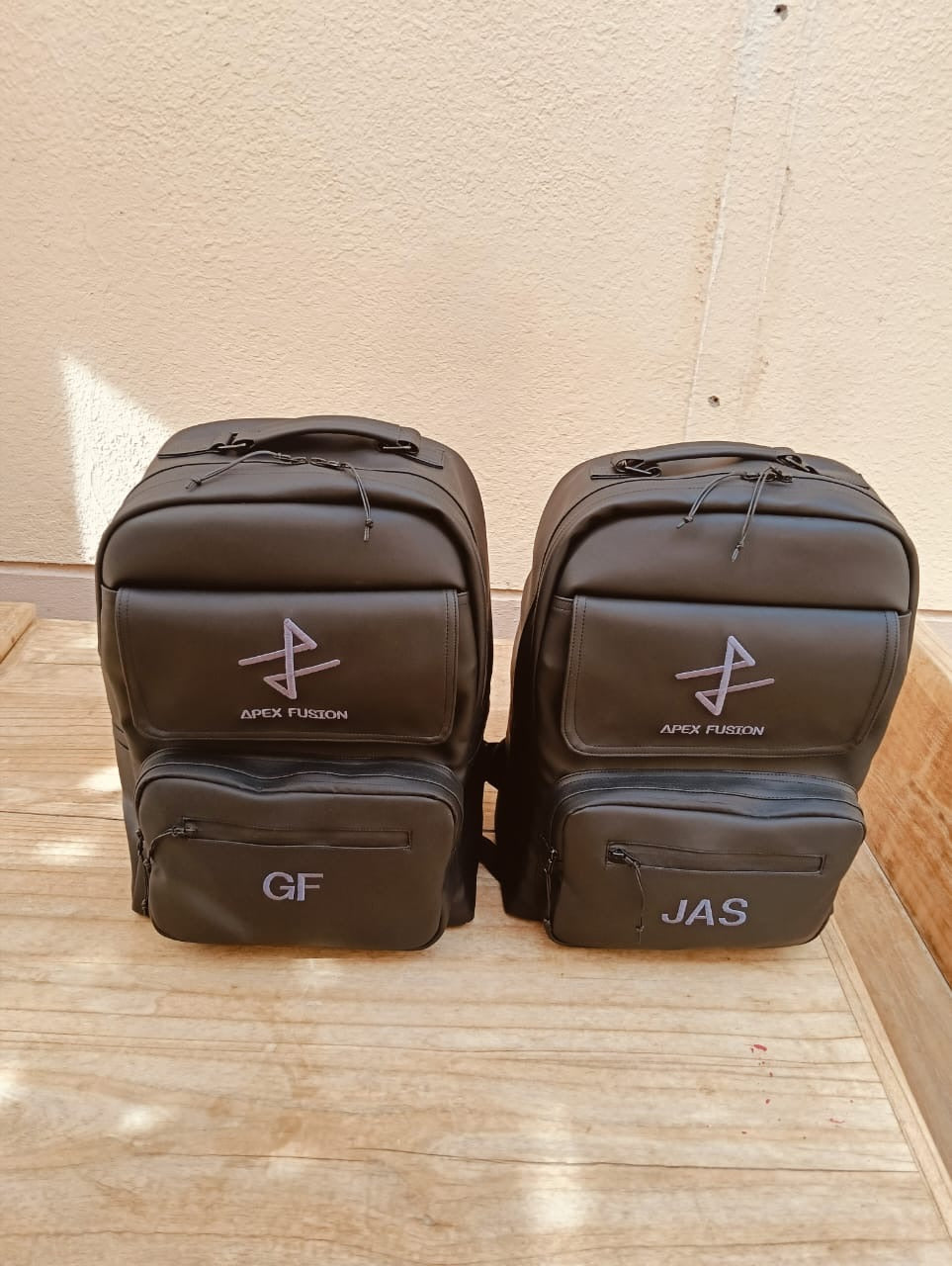 Custom YOUNfit backpacks branded for Apex Fusion with personalized initials